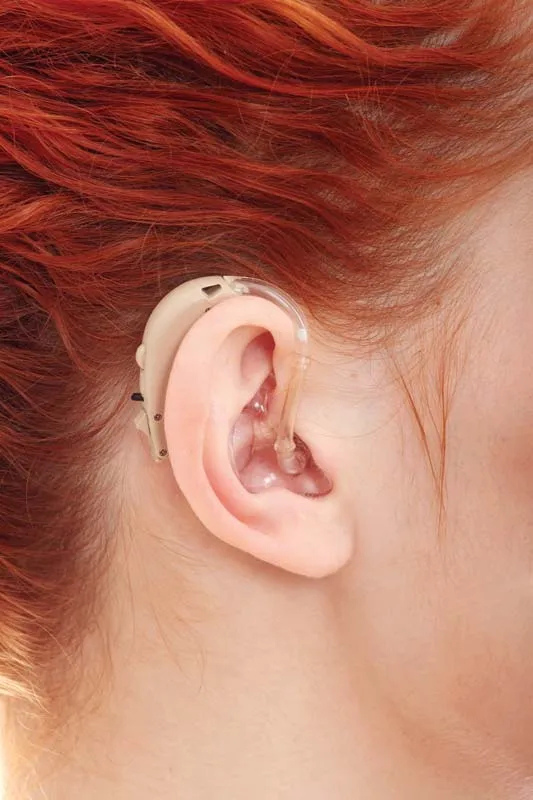 Red hair woman with hearing aid