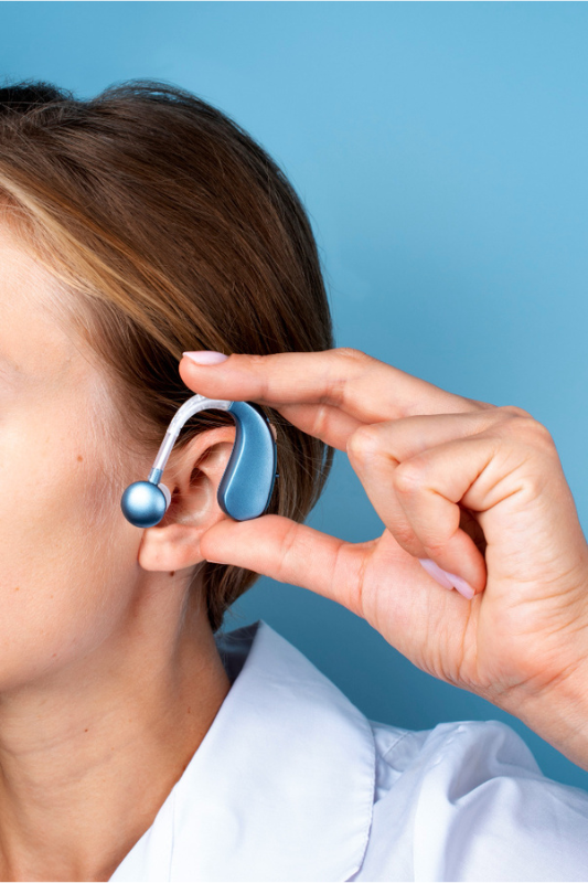 Blue hearing aid on woman